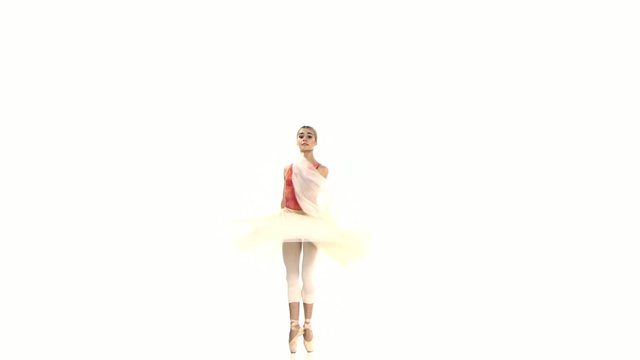 Young ballerina spinning on white background