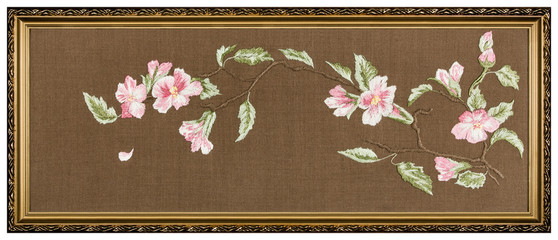 Embroidered picture in the frame, isolated on white background