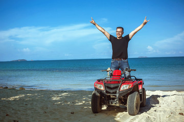 Happy ATV driver on the beach