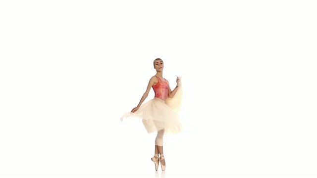 Young girl spinning and dancing ballet, on white background