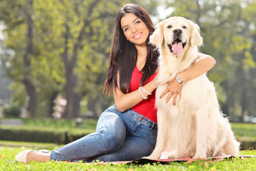 Young girl posing with her dog in park