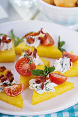 Polenta appetizers with ricotta and bacon