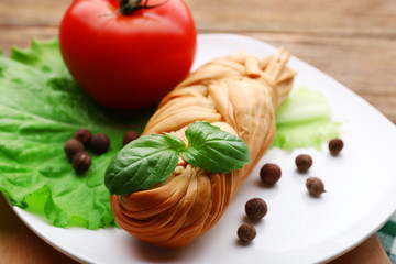 Smoked braided cheese on wooden table