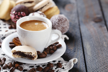 Gentle colorful macaroons and  coffee in mug