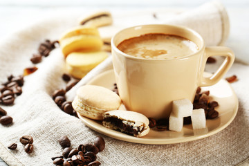 Gentle colorful macaroons and  coffee in mug