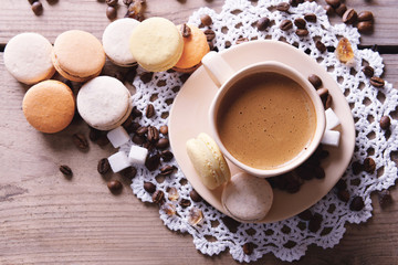 Gentle colorful macaroons and  coffee in mug