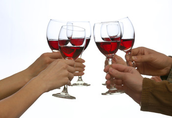 Clinking glasses of red wine in hands isolated on white