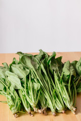 Fresh raw organic spinach wooden white background