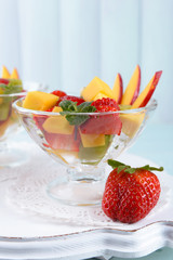 Fruit salad with mint in glassware