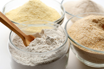 Different types of flour in bowls close up