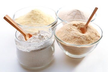 Different types of flour in bowls close up