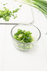chopped green onion in glass bowl