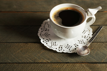 Cup of coffee on rustic wooden planks background