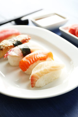 Sushi on plate on wooden table background