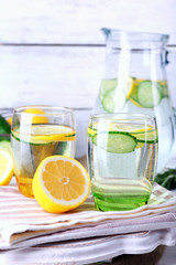 Fresh water with lemon and cucumber in glassware