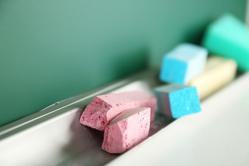 Chalk resting on school board, close up