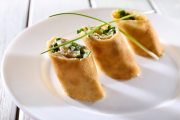 Pancakes with cream, cheese and greens in plate