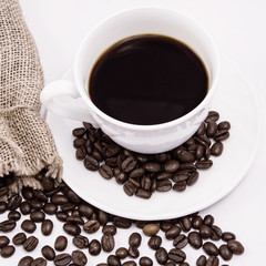 Coffee cup and beans on a white background.