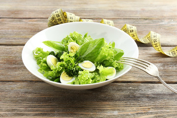 Salad with quail egg and basil in plate