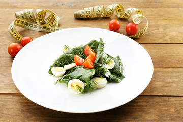 Salad with quail egg and basil in plate