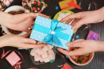 Female hands holding gift close-up