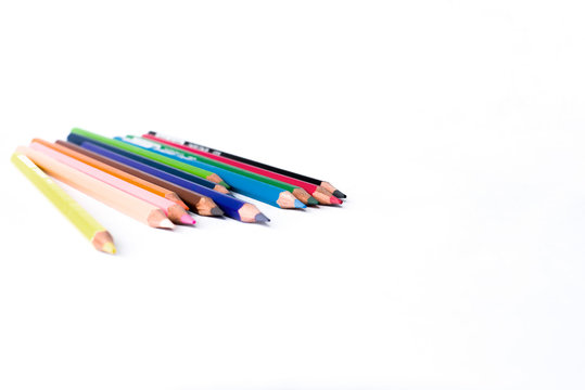 Colour pencils on isolated white background close up