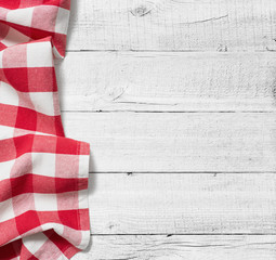 red folded tablecloth over white wooden table