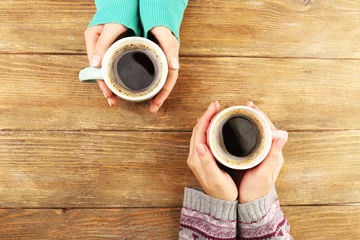 Foto op Canvas Female hands holding cups of coffee © Africa Studio