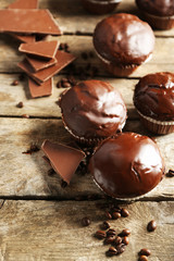 Tasty homemade chocolate muffins on wooden table