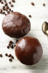 Tasty homemade chocolate muffins on wooden table