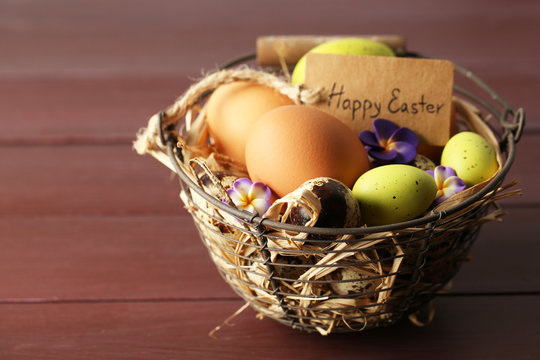 Bird eggs in wicker basket with decorative flowers