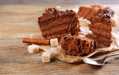 Slices of tasty chocolate cake on plate on table close up