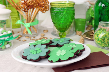Composition for St Patrick Day with sweets on table close up