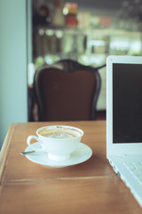 Coffee and white notebook in cafe.