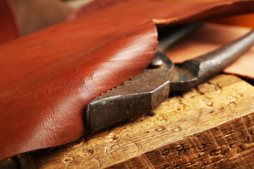 Leather belt and nippers on table close up