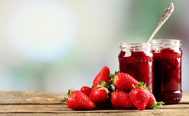 Jars of strawberry jam with berries