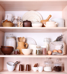 Kitchen utensils and tableware on shelves