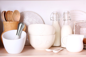 Kitchen utensils and tableware on shelf