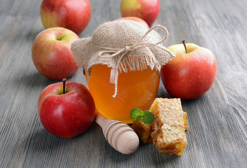 Delicious honey with apple on table close-up