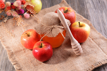 Delicious honey with apple on table close-up