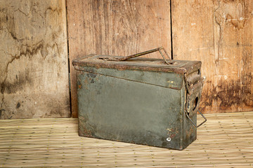 old ammunition box still life mat weave and wood board backgroun