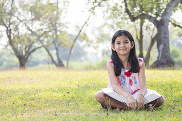 Girl sitting reading a book.