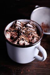 Mug of cocoa with marshmallows on wooden table, closeup