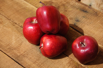 Fresh red apples on wooden background, Healthy fruit background.
