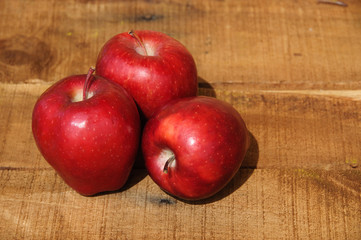 Fresh red apples on wooden background, Healthy fruit background.