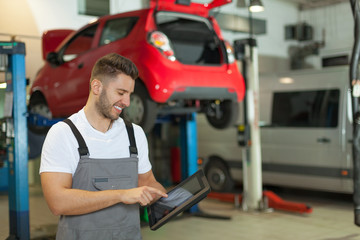 Fototapeta premium Mechanic using a digital tablet