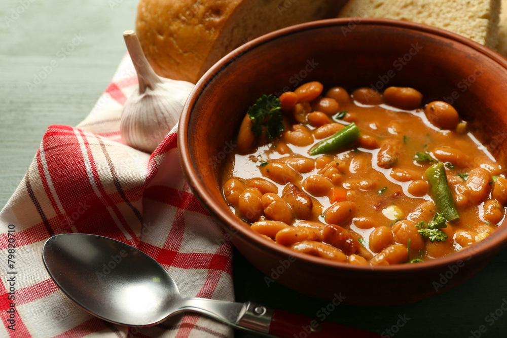 Canvas Prints Bean soup in bowl on napkin, on wooden table background