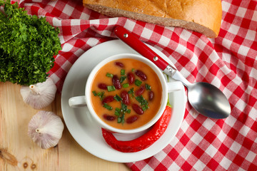 Bean soup in bowl with fresh sliced bread
