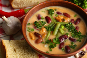 Bean soup in bowl with fresh sliced bread