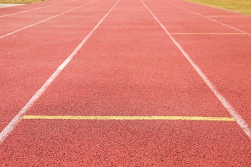 Fototapeta premium Lines and arrows of running racetrack in outdoor stadium